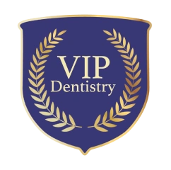Blue and gold shield emblem with laurel wreath and text VIP Dentistry.